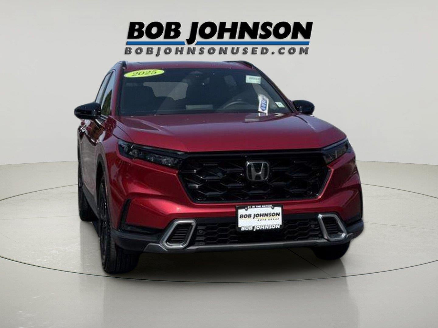 2025 Honda CR-V Hybrid Sport Touring in Radiant Red Metallic — front three-quarter view