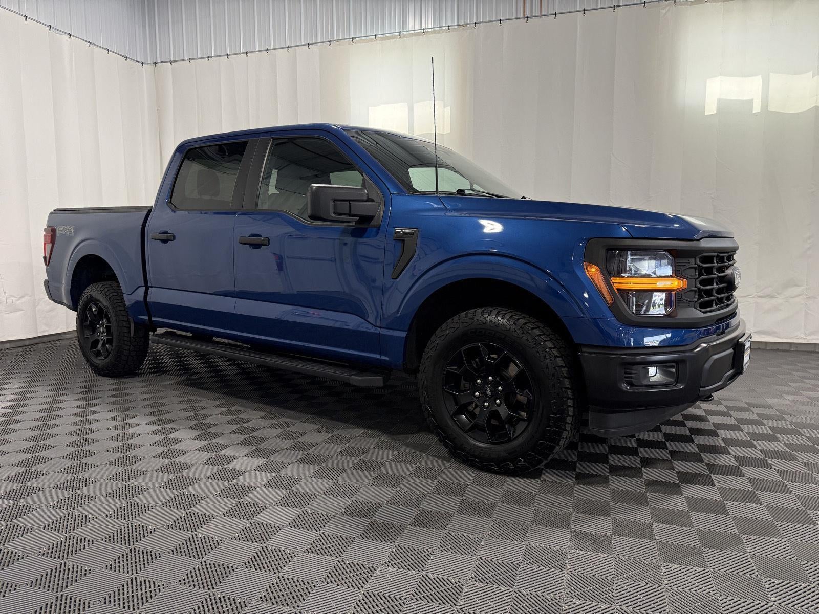 2024 Ford F-150 STX in Atlas Blue — front three-quarter view
