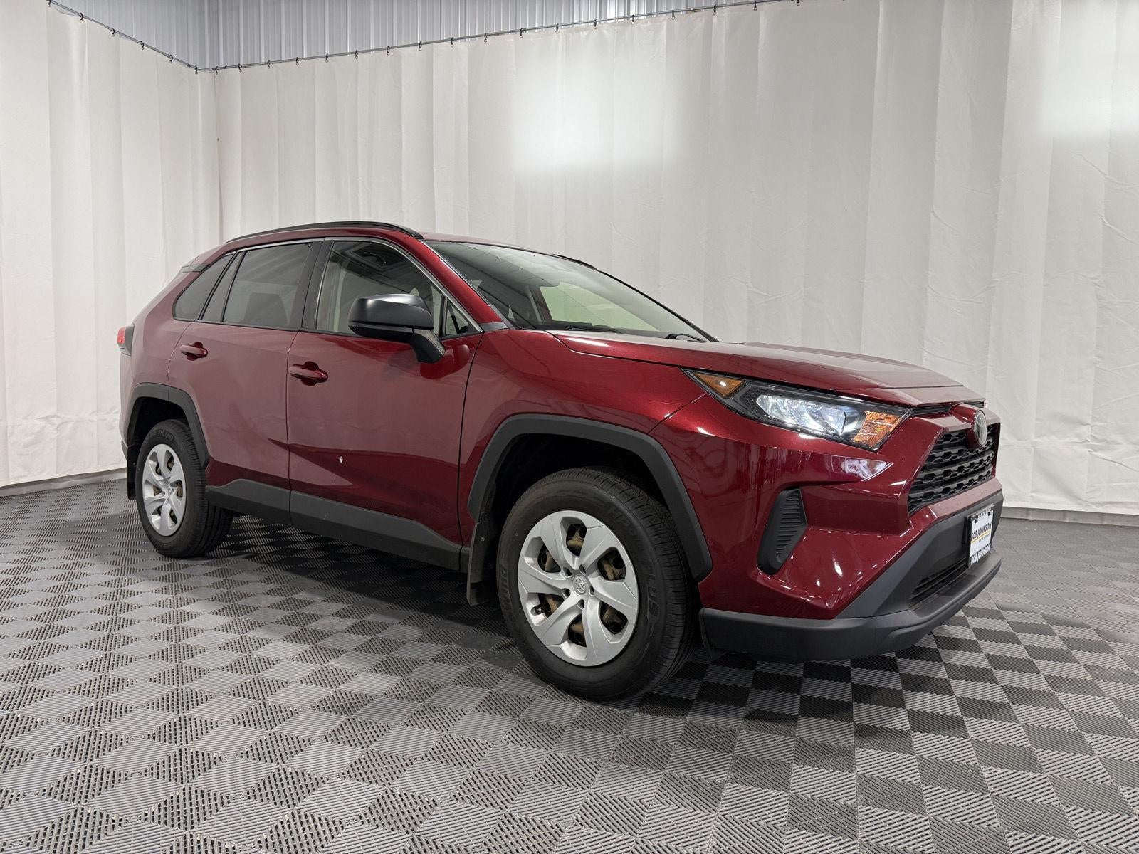 2019 Toyota RAV4 LE in Ruby Flare Pearl — front three-quarter view
