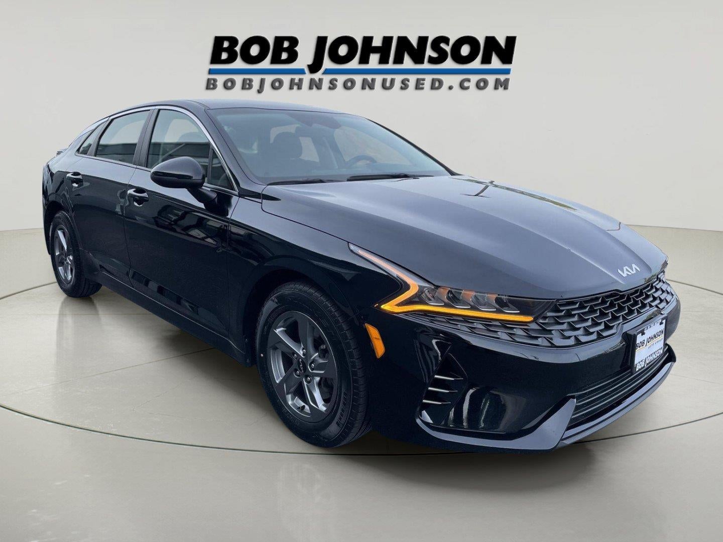 2024 Kia K5 LXS in Ebony Black — front three-quarter view